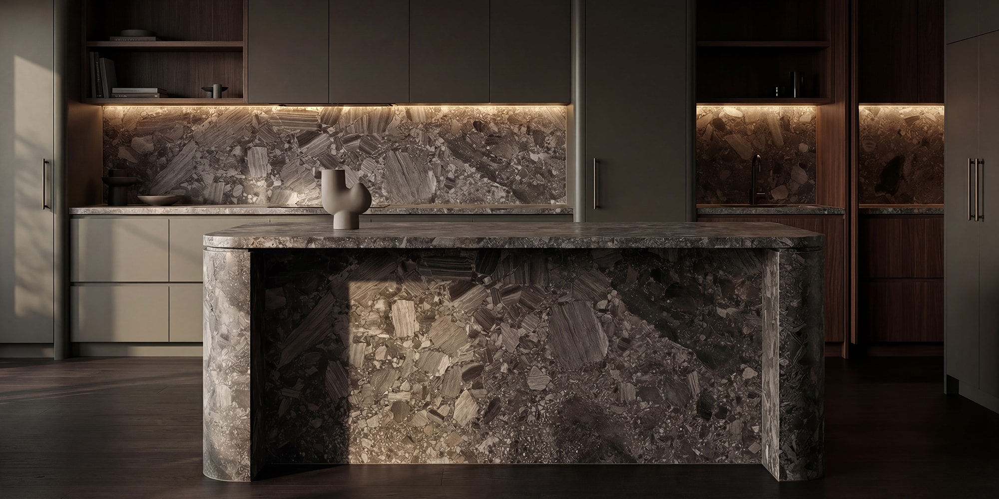 Marble island benchtop and splashback in a dark contemporary kitchen