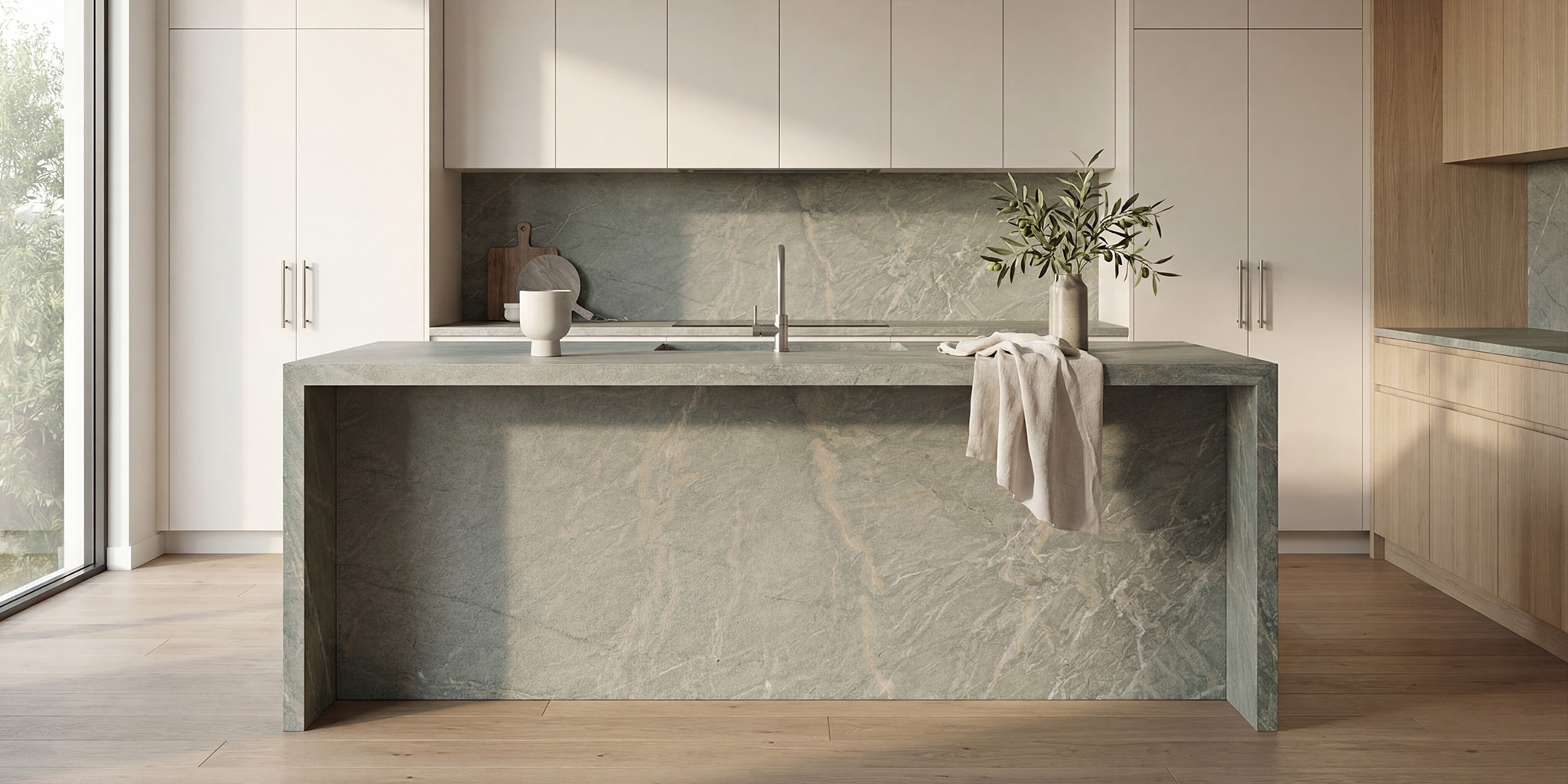 Granite island benchtop and splashback in a light contemporary kitchen